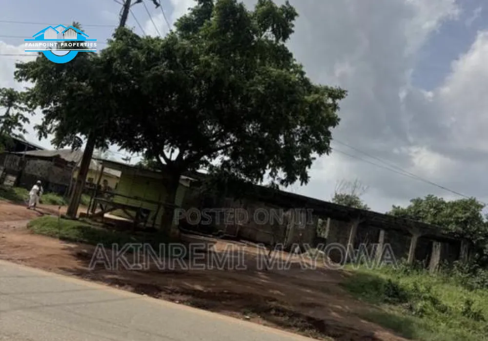 1 Acre of Land Fenced directly With 4 Shops