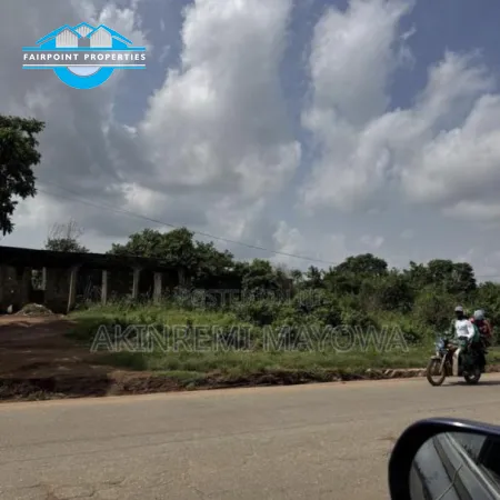 1 Acre of Land Fenced directly With 4 Shops