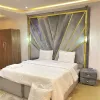 Large Bedroom - fitted with king size bed, smart Tv that comes with DSTv full package and netflix, Air conditioner, luxury bathroom, and luxury decorations
